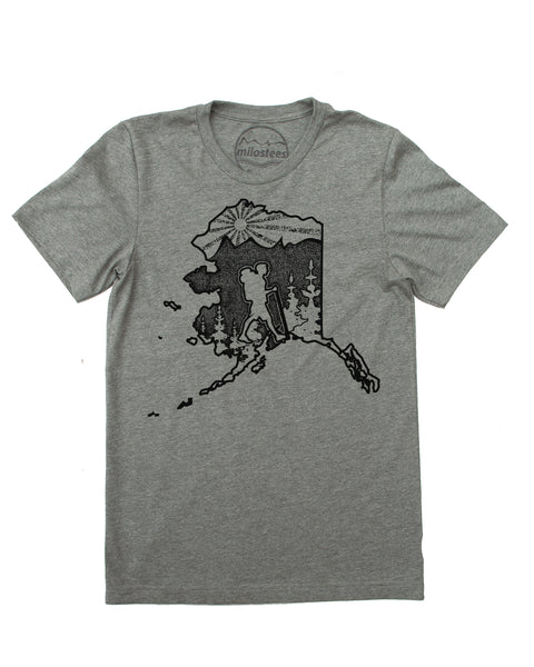 Hike Alaska shirt with original hand screen printed illustration of a hiker in the state of Alaska complete with trees, mountains and setting sun. Print on grey cotton, polyester blend. $21.99, free shipping in USA. Elevate the Day!  