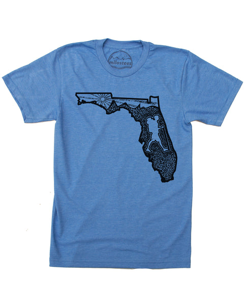 Graphic illustartion of a hiker in state of Florida, complete with rolling hills and setting sun all infill the state. Black ink on a cotton, polyester blend in a blue hue by American Apparel. $21.99, free shipping in USA