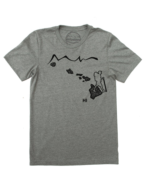 Hawaii home tee with hiking illustration complete with mountainous volcanos a hiker and the islands. Hand screen print on soft cotton, polyester blend in a grey hue. $21.99, free shipping in the USA. 