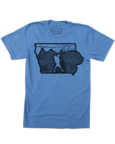 Iowa home shirt with original illustration of a hiker in the middle of the state surrounded by rolling hills and a setting sun. Cotton, polyester blend by American Apparel in a blue hue. Print is black ink. $21.99, free shipping in USA. 
