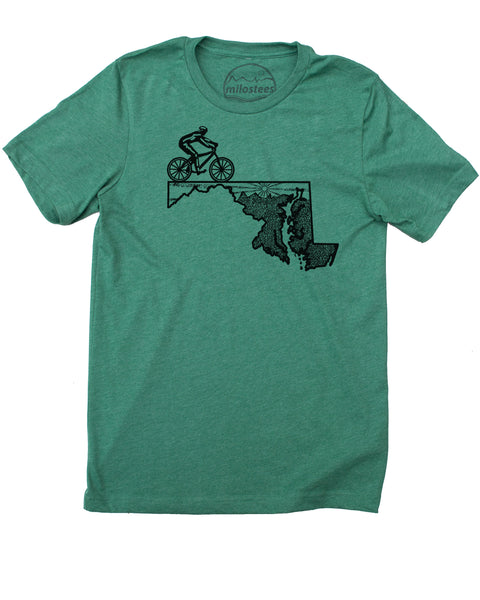 Bike Maryland shirt-  A setting sun and rolling hills infill the top portion of the state while a cyclist is riding the top left  of the state outline,, color grass green