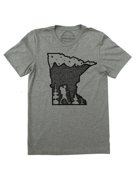 Hike MN screen print, graphic with hiker along bottom of state outline surrounded by trees. Mountains infill the top 3/4 down (mtns made with tiny dots) , satrs and the North Star in top 1/4 of design. Color grey, soft cotton, polyester blend by Bella + Canvas. $21.99, free shipping in USA. 