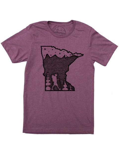 Hike MN screen print, graphic with hiker along bottom of state outline surrounded by trees. Mountains infill the top 3/4 down (mtns made with tiny dots) , satrs and the North Star in top 1/4 of design. Color plum, soft cotton, polyester blend by Bella + Canvas. $21.99, free shipping in USA. 