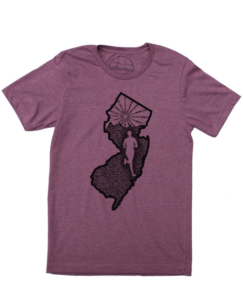 New Jersey home shirt with a runner illustration, runner inside the state outline, rolling hills and a setting sun also infill the state. Hand screen printed on a plum hue in a cotton, polyester blend. $21.99, free shipping in USA. Elevate the day! 