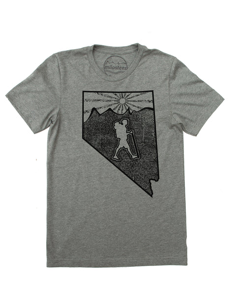 Hike hiking the middle portion of Nevada, mountains and setting sun are above the hiker, the land is made of tiny dots, thousands and the hiker is outlined by all these tiny dots. all elements infill the state of NV. Shirt is a cotton, polyester blend by Bella + Canvas in a grey hue. $21.99, free shipping in USA.  Elevate the day!